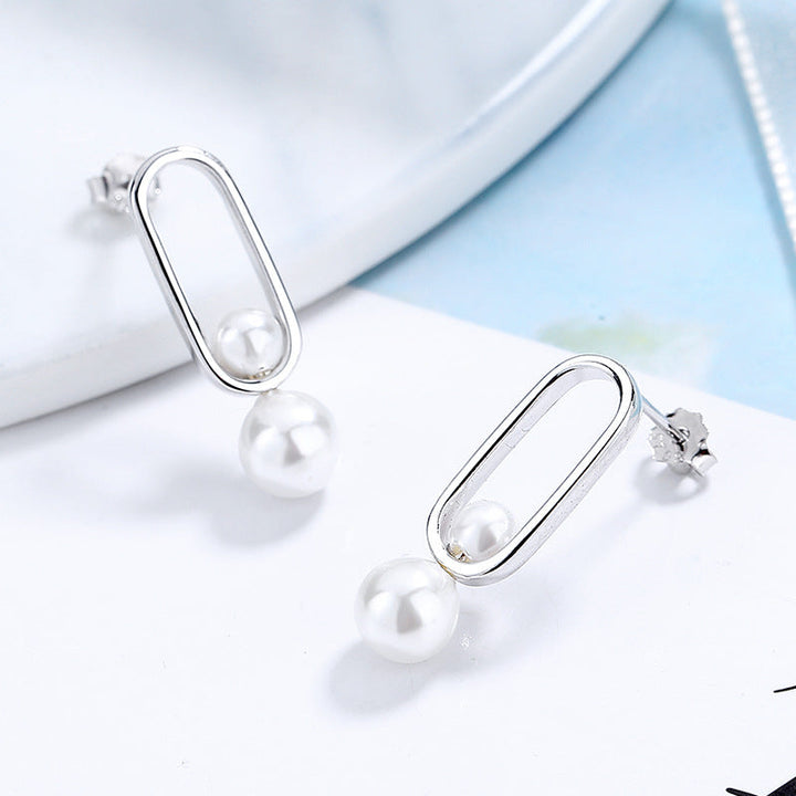 Women's stud earrings with modern oval design and elegant pearls Land Girl