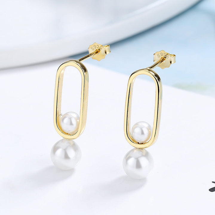 Women's stud earrings with modern oval design and elegant pearls Land Girl